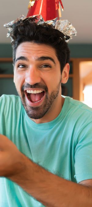 portrait-young-man-celebrating-his-birthday-video-call-opening-presents-while-staying-home